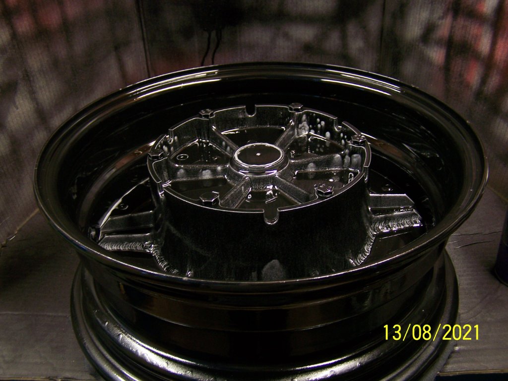 First coat of black on the rim and hub bolted together (using sacrificial bolts)