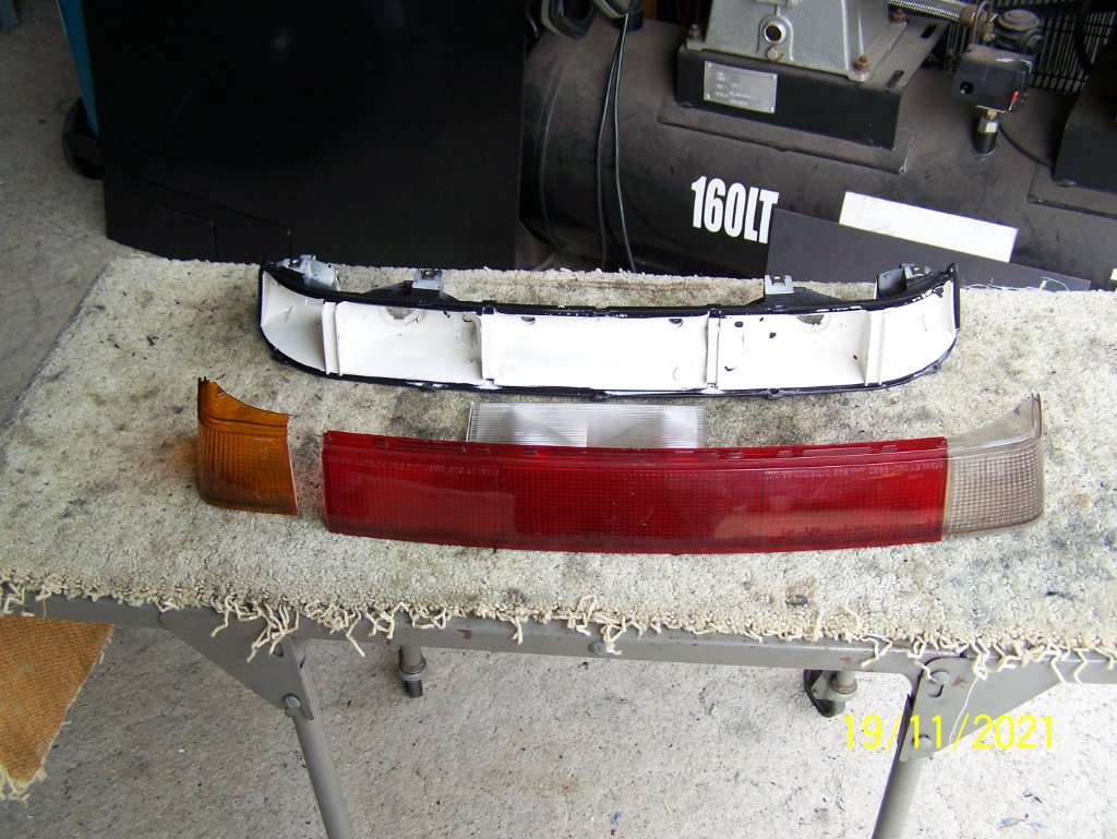Tail light lenses, they are upside down on the bench.