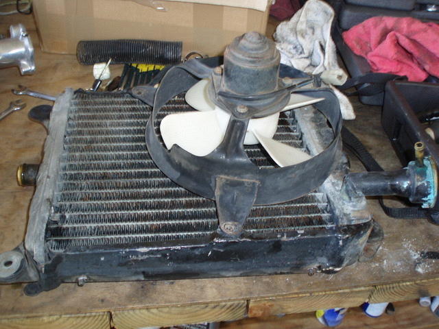 Radiator removed, fan will be removed an not reused.  I cleaned radiator, but did not send out for service.