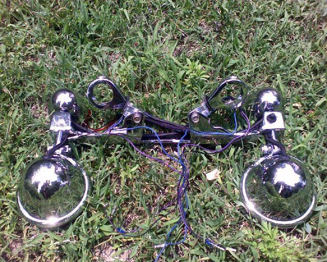 Fork clamps with L brackets to make lightbar from Shadow ACE fit GL1100 forks.