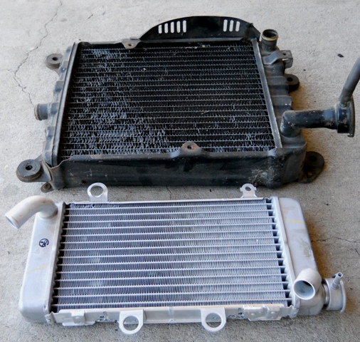 FACTORY STOCK 7 AND A HALF POUND RADIATOR AND IT'S REPLACEMENT AN ALUMINUM 1 AND A HALF POUND RACING RADIATOR