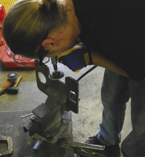 FINISHING GRINDS ON THE NOW CUTOUT SWINGARM MOUNTING PLATE BY CHRIS