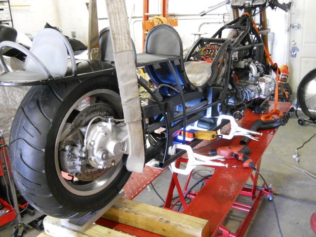 Rear end of bike on lift with hoist to get to belly pan for rivets-did this yesterday Aug 3rd!