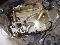 Cover removed, water pump in lower left with signs of water leakage
