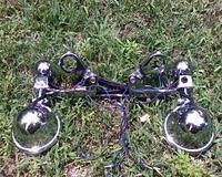 Fork clamps with L brackets to make lightbar from Shadow ACE fit GL1100 forks.