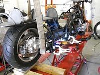 Rear end of bike on lift with hoist to get to belly pan for rivets-did this yesterday Aug 3rd!